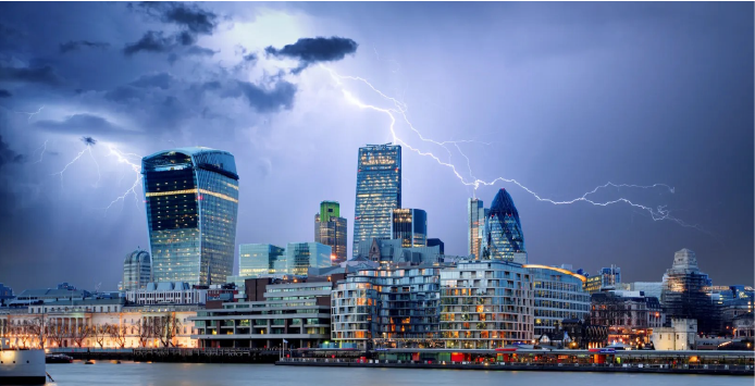 Lightning striking over a city skyline of high-rise buildings during a storm